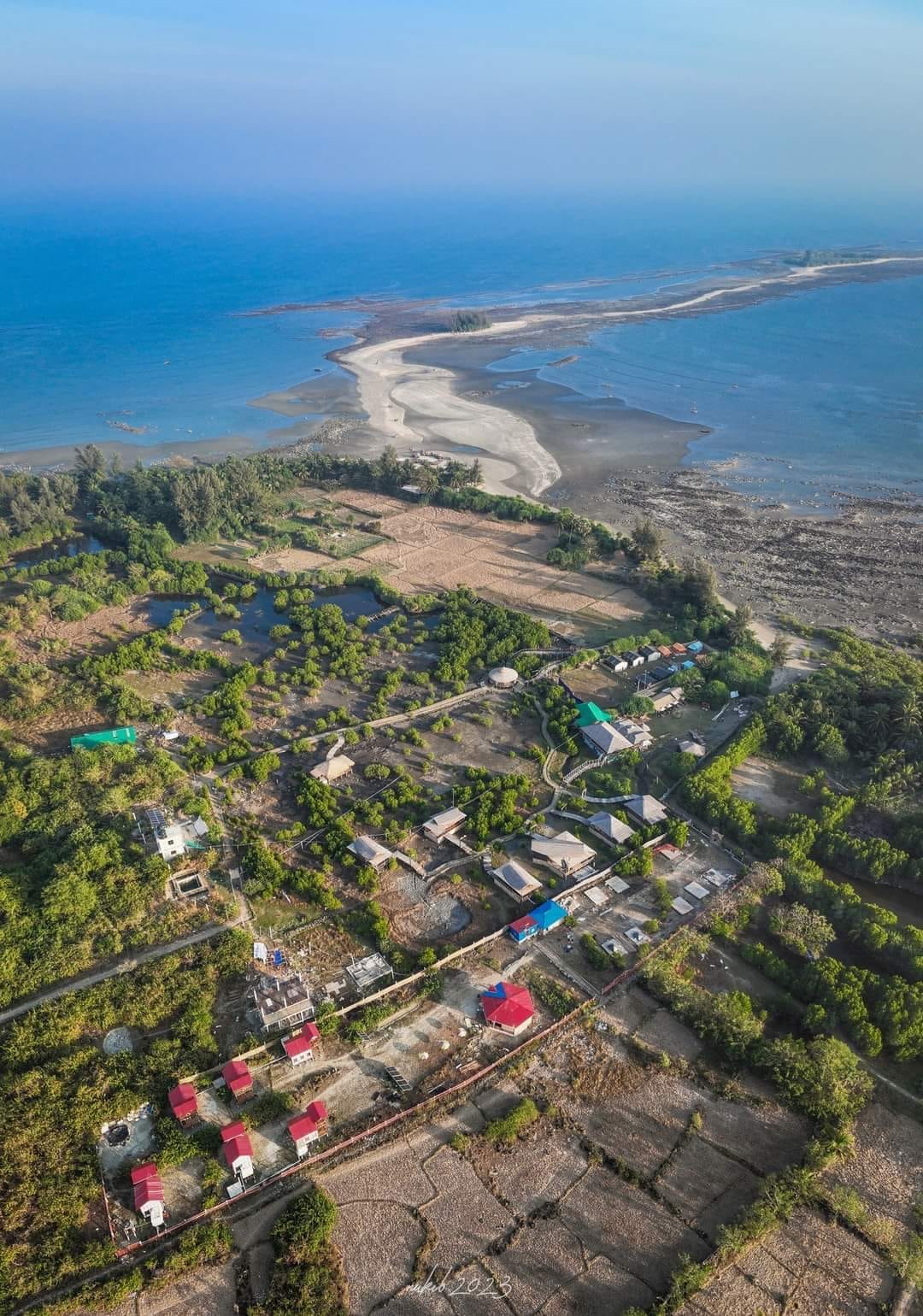 Aerial view over the island's villages, trees and coastline