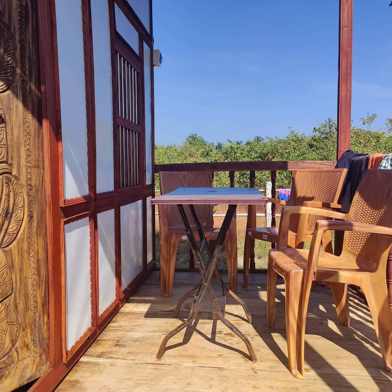 Cottage balcony with a table and chairs