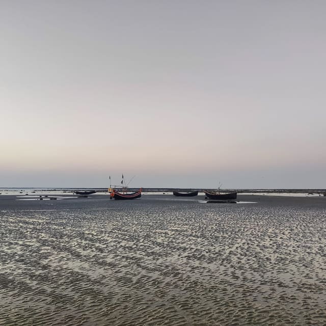 Fishing boats at low tide on a calm beach